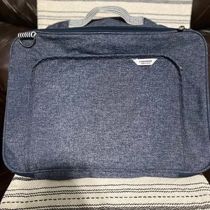 Funnymade, navy blue travel bag with striped straps.